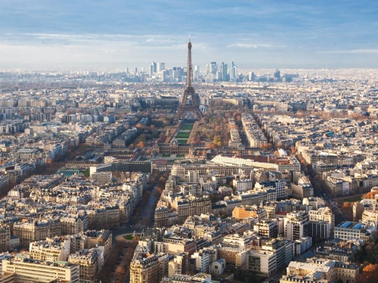 View from Montparnasse Tower Paris with the Eiffel Tower in the center of the photo and La Defense visible behind it