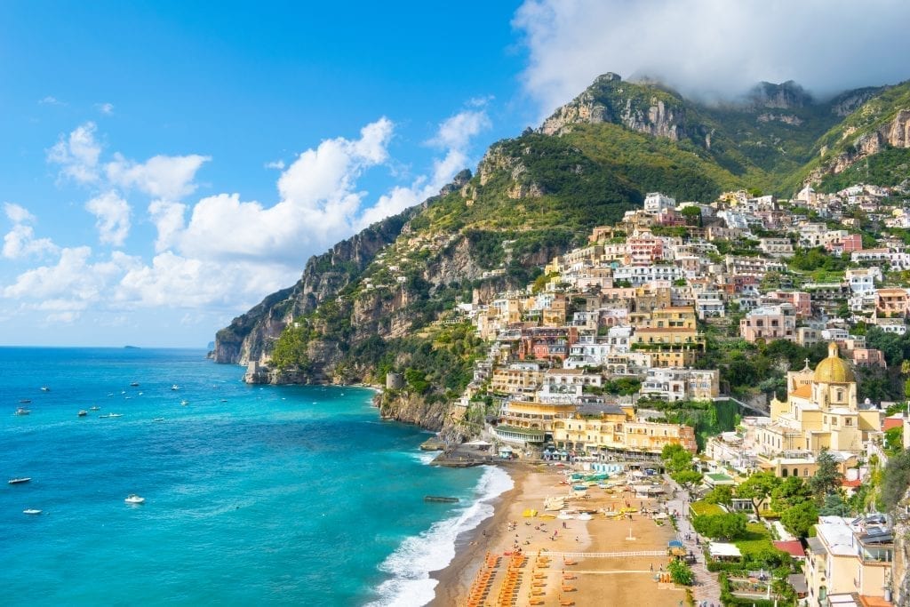 View of Positano with its beach in the foreground and the sea to the left. Postiano is one of the best places to visit in Italy
