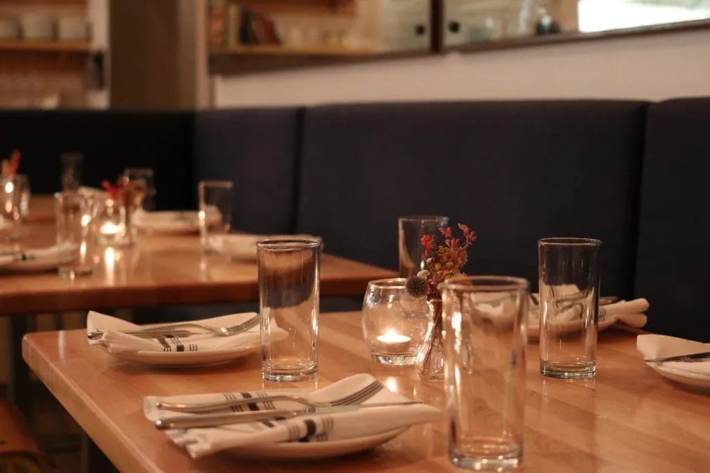 Place settings at a nice restaurant with black booths
