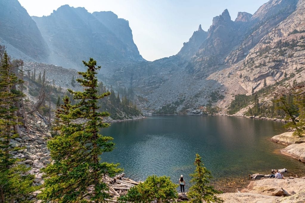 Kate Storm standing in front of Emerald Lake in Rocky Mountain National Park Colorado