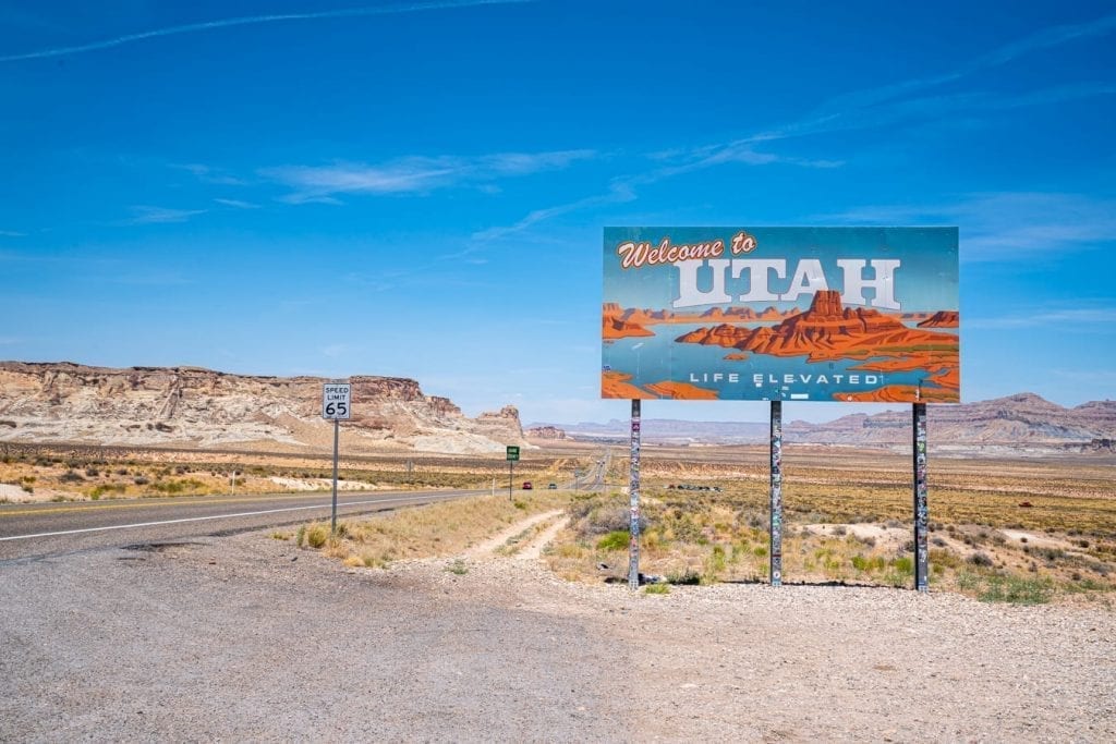 welcome to utah sign on the utah arizona border on a national parks utah road trip