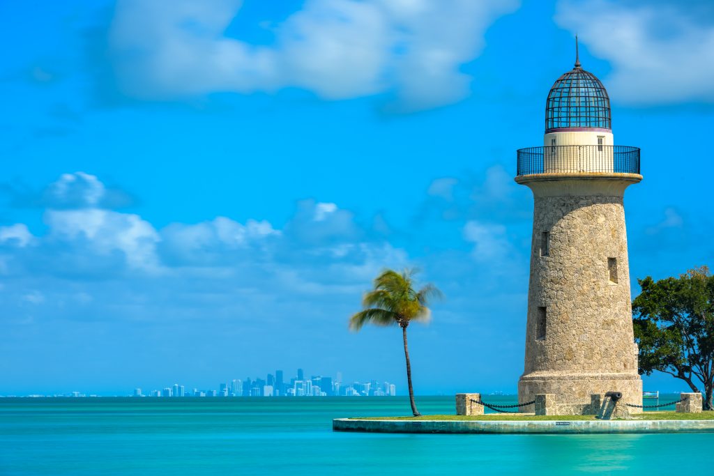 boca chita lighthouse in biscayne national park with miami skyline in the far distance