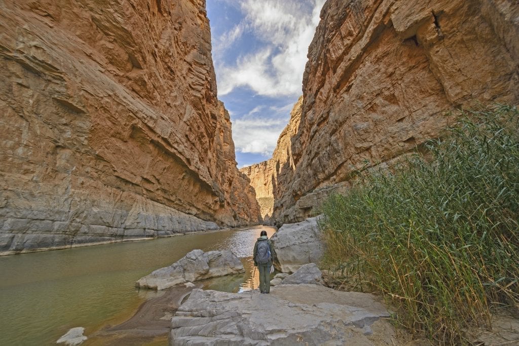 hiker standing in santa elena canyon in big bend national park texas, one of the coolest usa national parks to visit winter