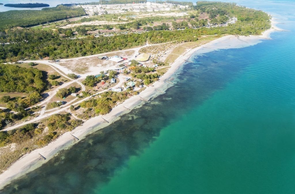 Biscayne National Park as seen from above with the beach to the left and the bright blue water to the right