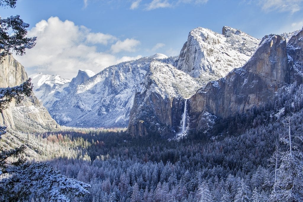 view of half dome and yosemite falls in winter from across the valley