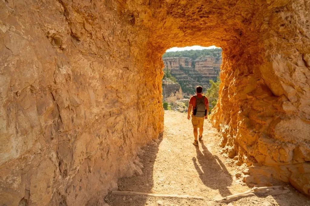 jeremy storm hiking through a tunnel on bright angel hiking trail