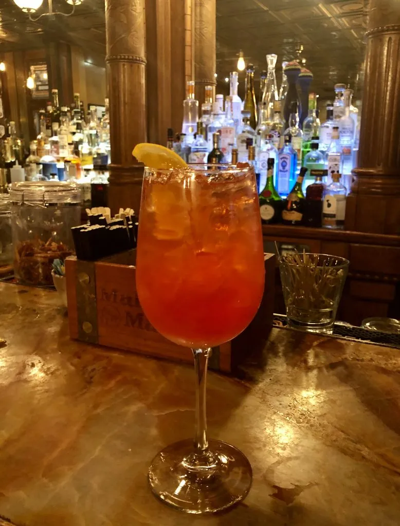 orange cocktail on the bar counter at the stanley hotel estes park things to do