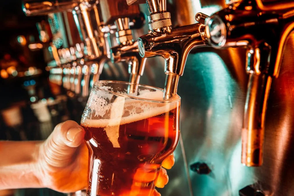 bartender pulling a beer from a tap