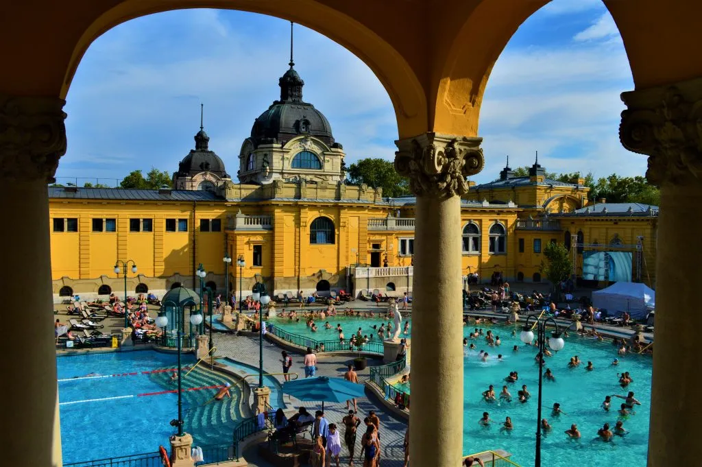 view of Szechenyi Thermal Baths from under an arch in budapest hungary