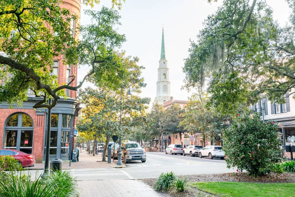 beautiful square in savannah ga with church steeple in the background
