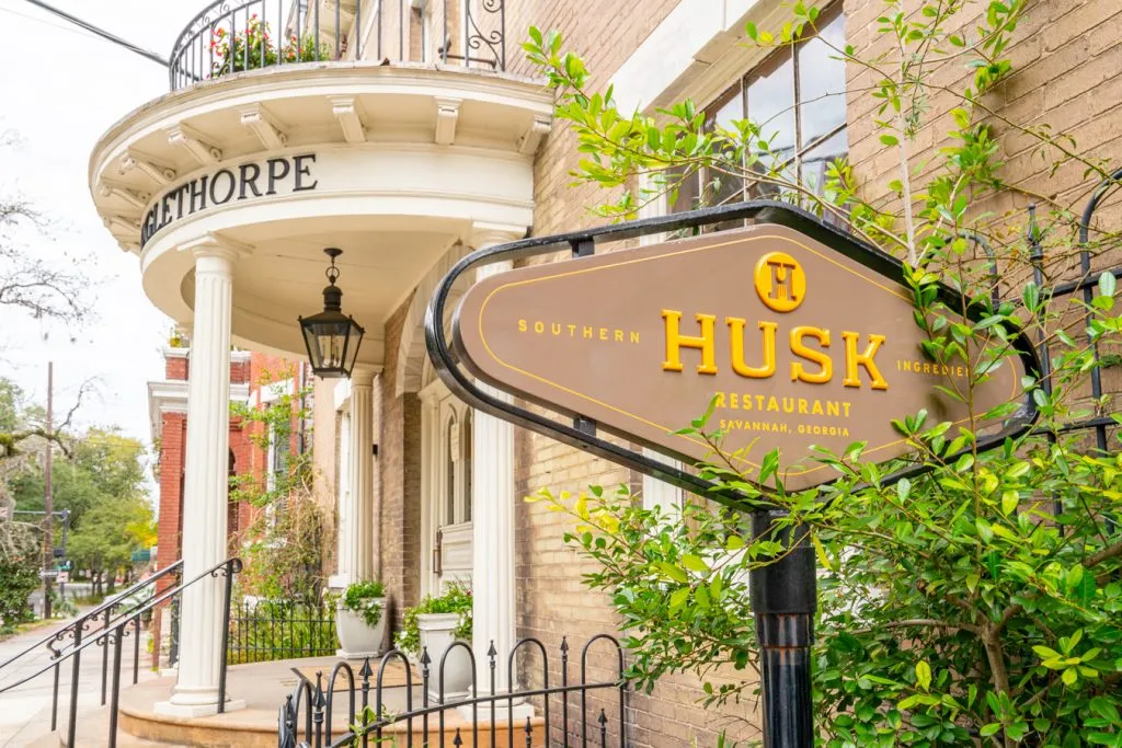 exterior of husk showing its sign, one of the best restaurants in savannah ga