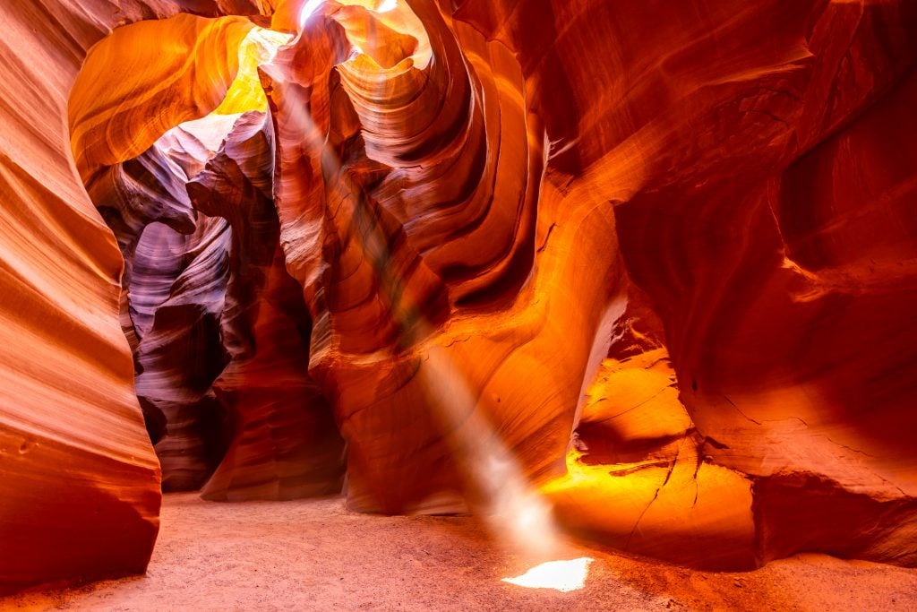 image of antelope canyon, one of the best places to visit in page arizona, with a beam of light in the center