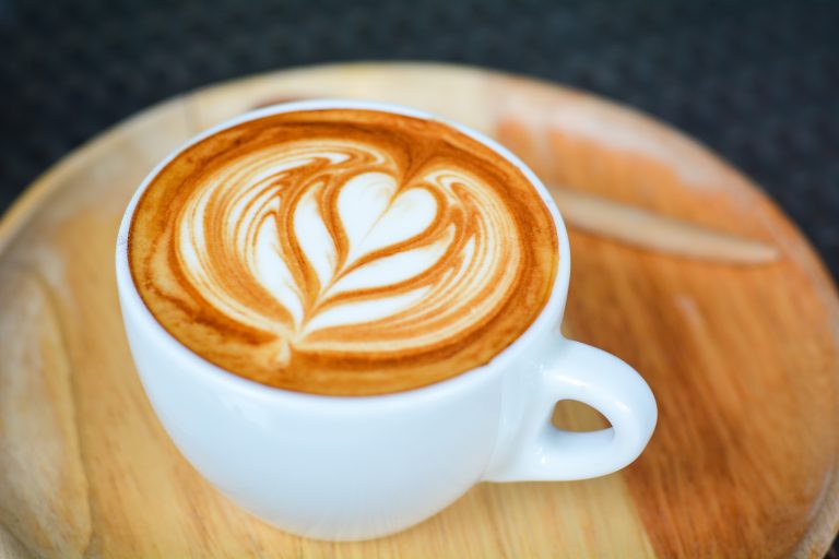 latte sitting on a wooden table, a common sight at the best coffee shops in savannah ga