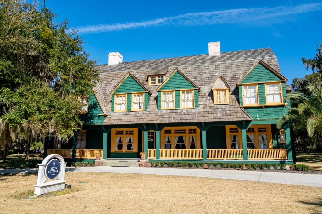 front facade of moss cottage, green with yellow trim, on jekyll island georgia