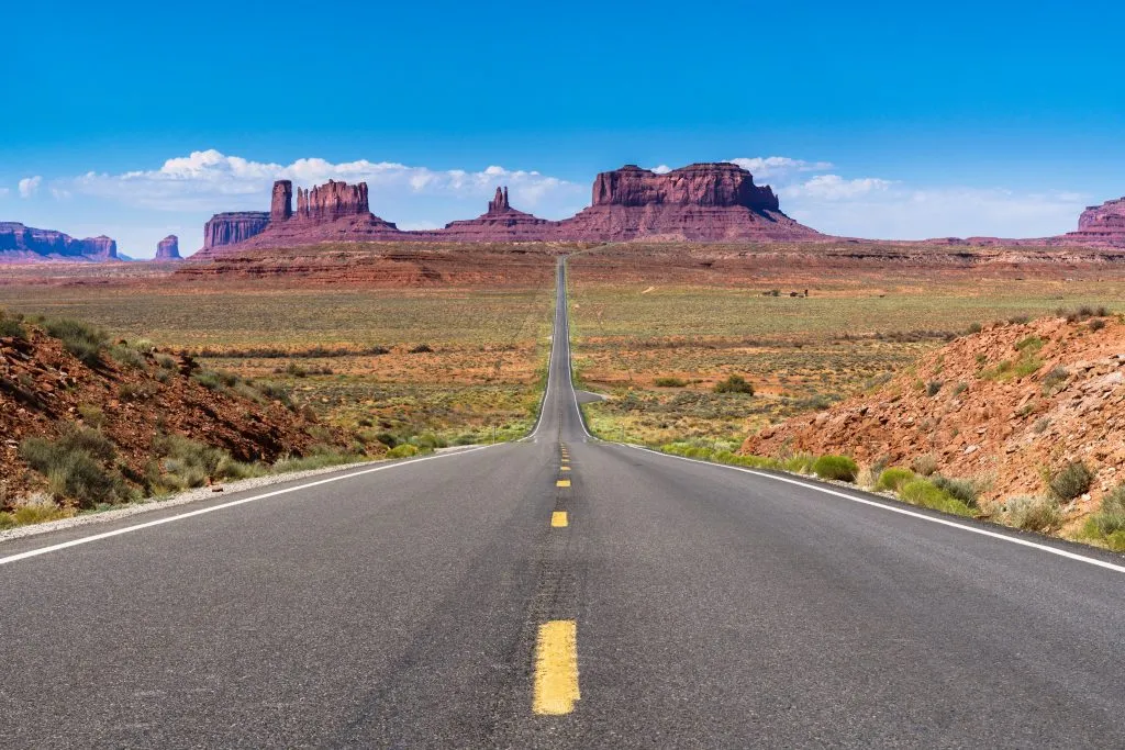 view of monument valley utah with the 2 lane road in the center of the image