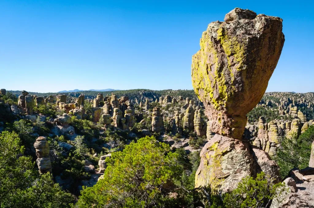 view of Chiricahua National Monument with a large, balancing boulder in the foreground.