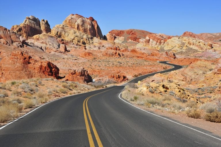 winding road through a rocky landscape on a usa southwest road trip itinerary