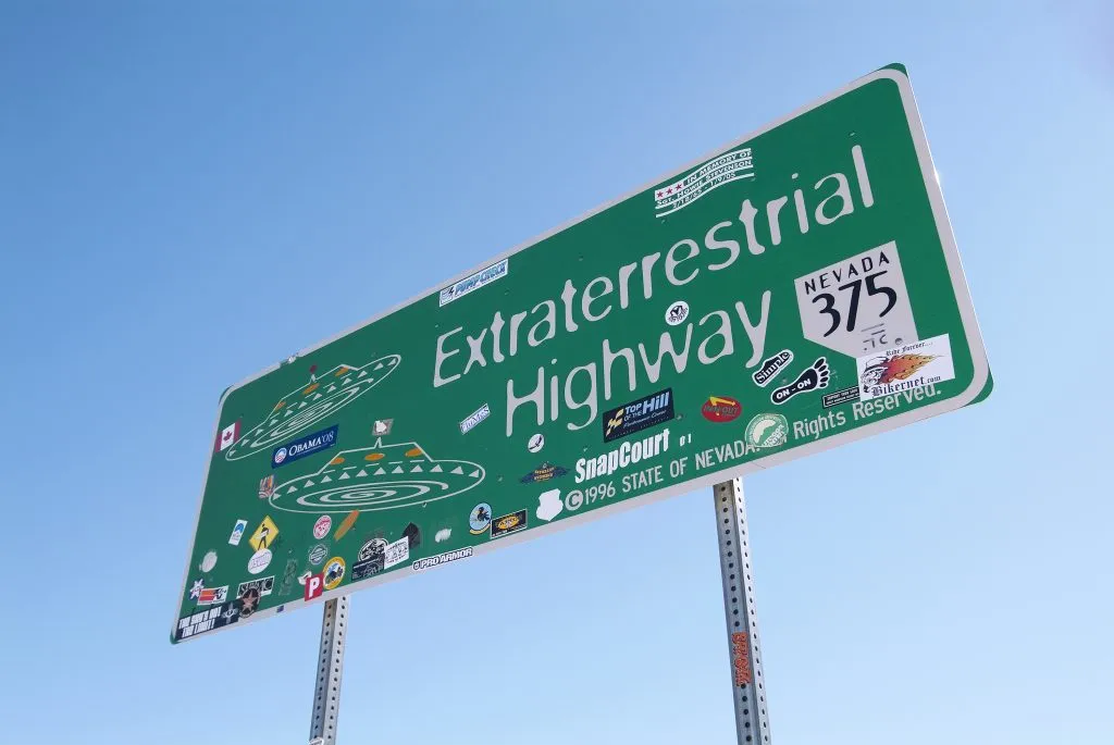 photo of a green sign in nevada reading "extraterrestrial highway", as seen during one of the best southwest road trip itinerary ideas