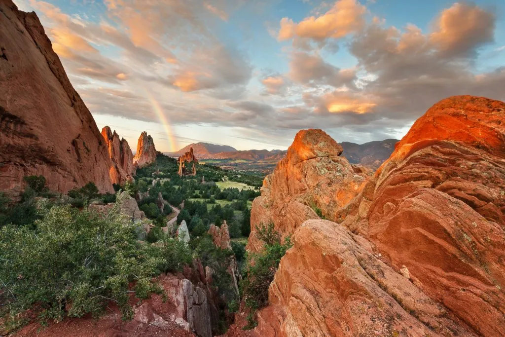 sunset views of the red rocks at colorados garden of the gods, one of the best road trips in southwest usa