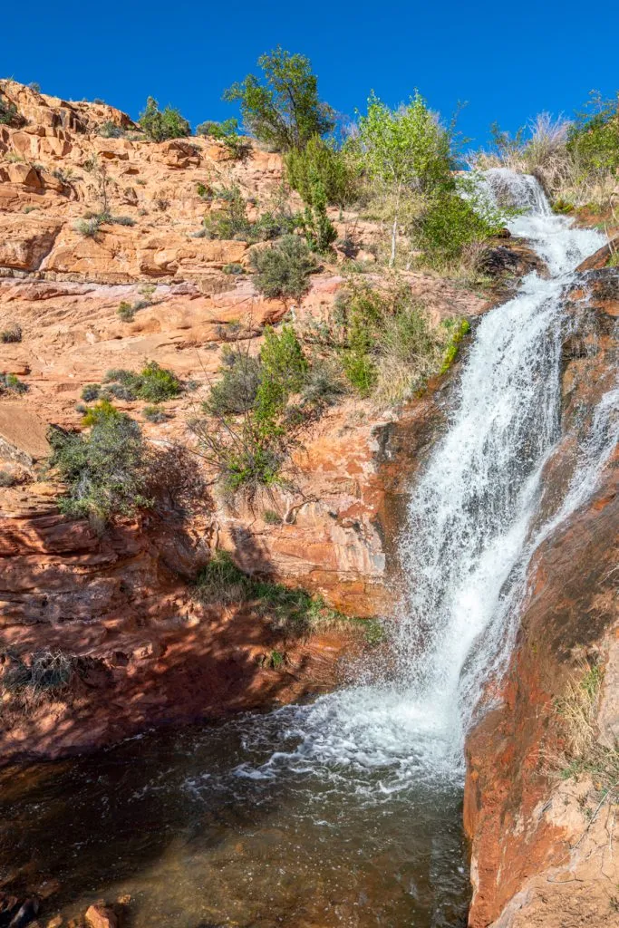 vertical photo of faux falls, one of the best things to do in moab utah