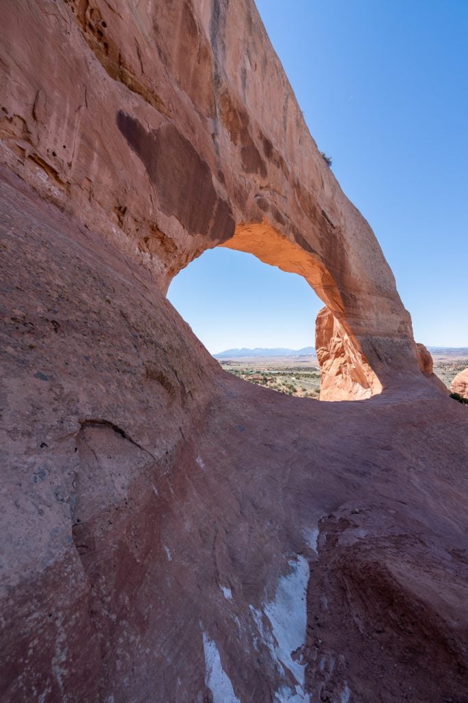 vertical view of utah wilson arch moab as seen from hiking trail