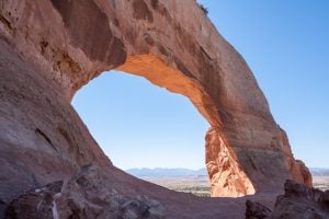wilson arch utah with blue sky visible through it