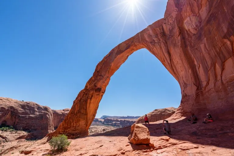 corona arch trail in moab utah on a sunny day, with arch centered in the photo