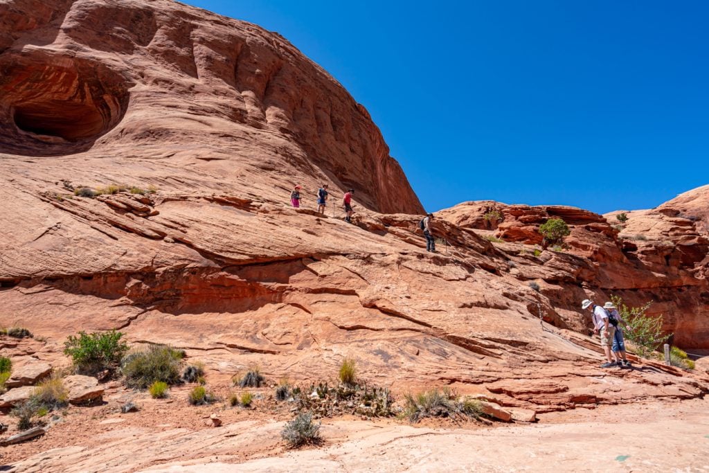 hikers along trail in moab utah