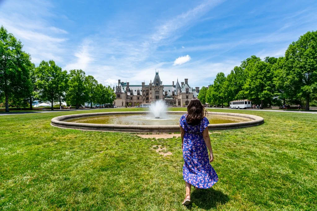 kate storm in a blue dress in front of the biltmore house asheville north carolina