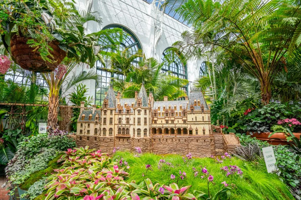 interior of biltmore conservatory with model biltmore house in the center