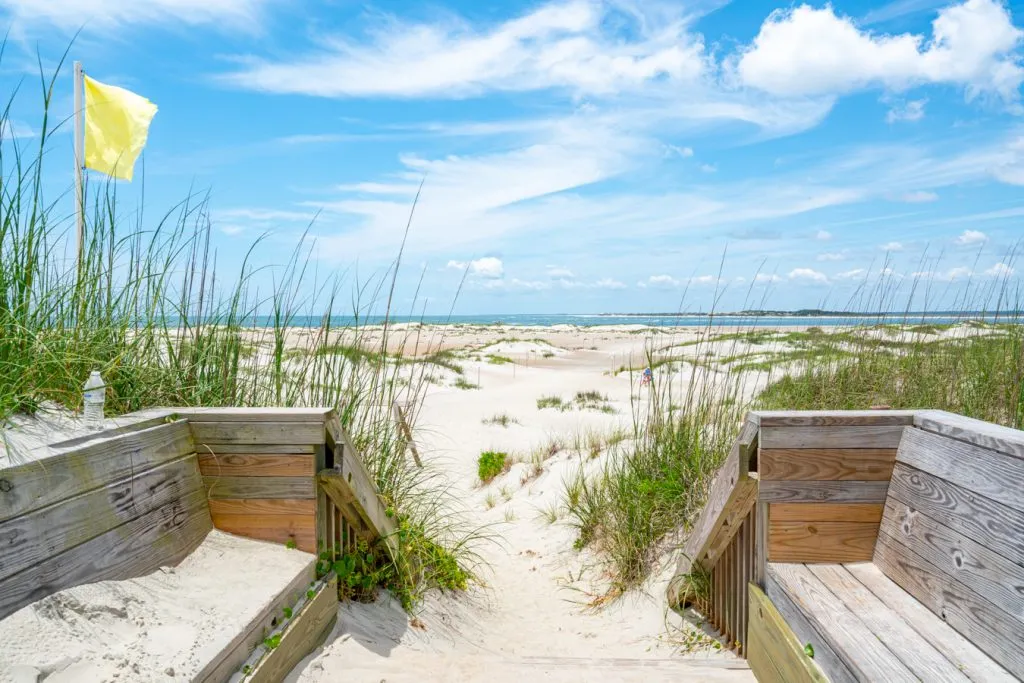 sandy steps leading to the point with yellow flag blowing home of top activities in emerald isle nc