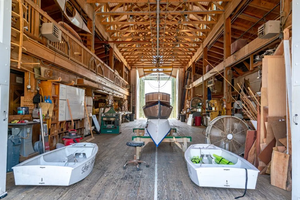 interior of the harvey w smith watercraft center with boat being built in the center, one of the top beaufort attractions