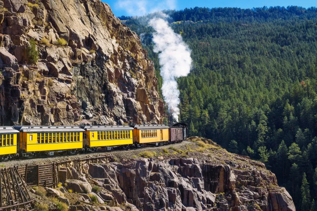 historic yellow narrow gauge train between durango and silverton, some of the best colorado mountain towns