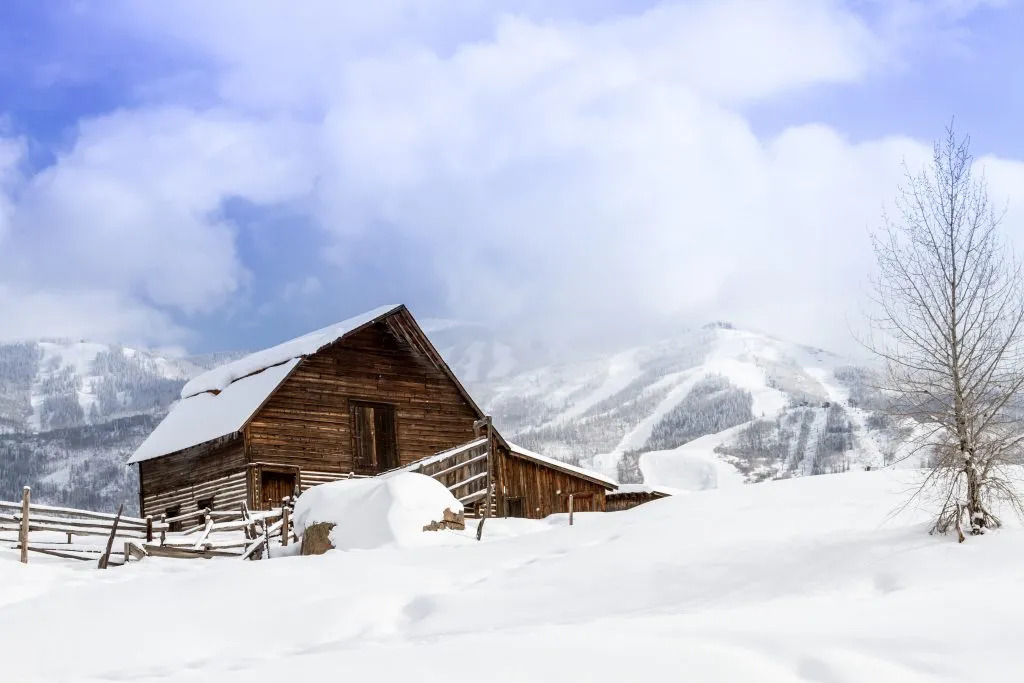 historic barn covered in snow in steamboat springs co, one of the best vacation spots in colorado