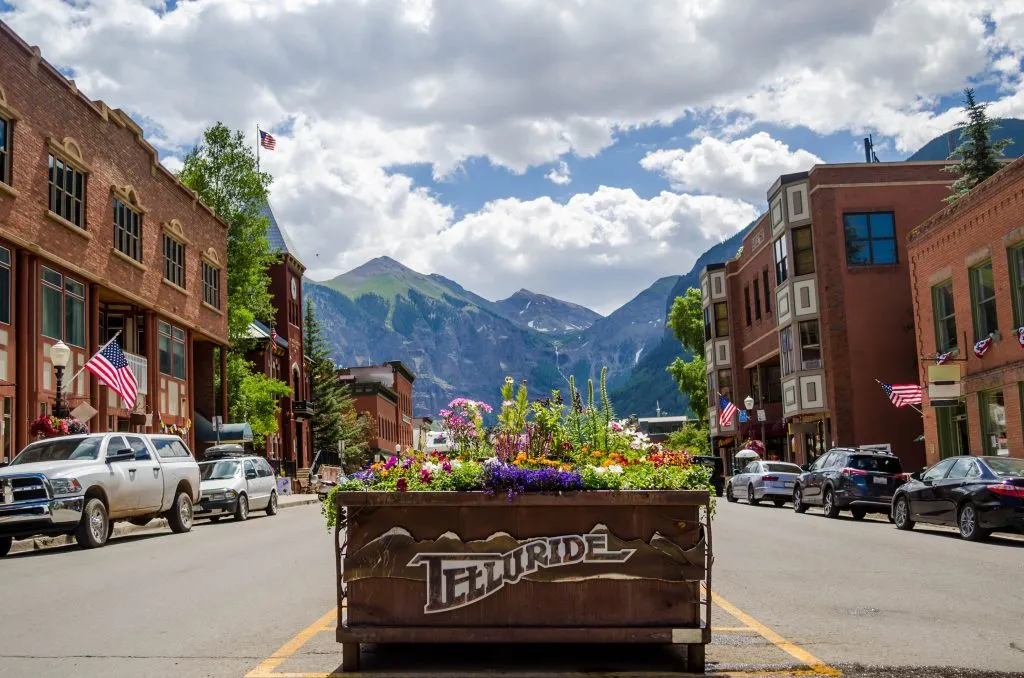 downtown telluride colorad with mountains in the background, one of the best colorado travel destinations