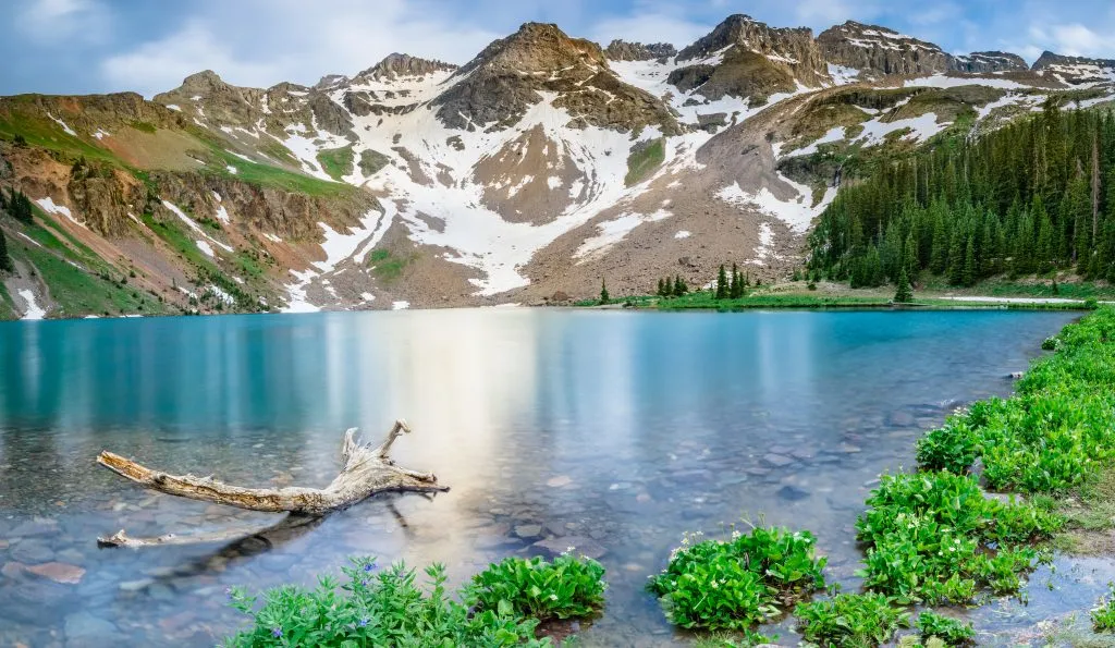 blue lake in colorado with mountains in the background, near one of the best colorado vacation spots telluride