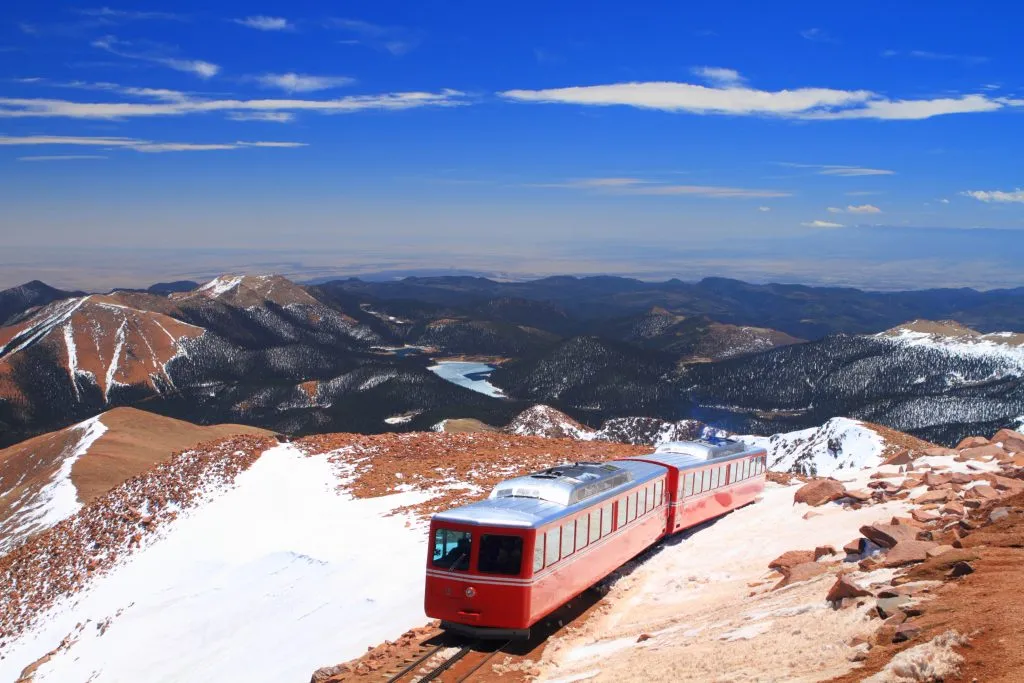 red pikes peak train climbing the mountain, one of the coolest places in colorado