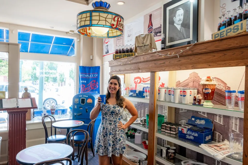 kate storm holding up a pepsi in the birthplace of pepsi cola, one of the best activities new bern nc