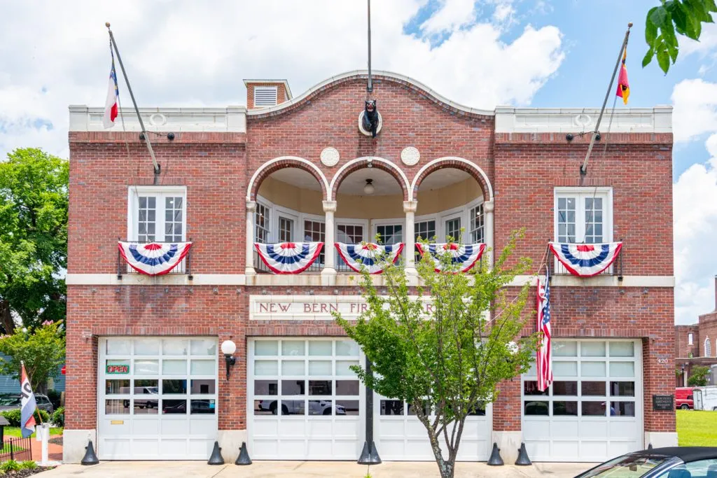 front facade of new bern fire museum decorated with flags