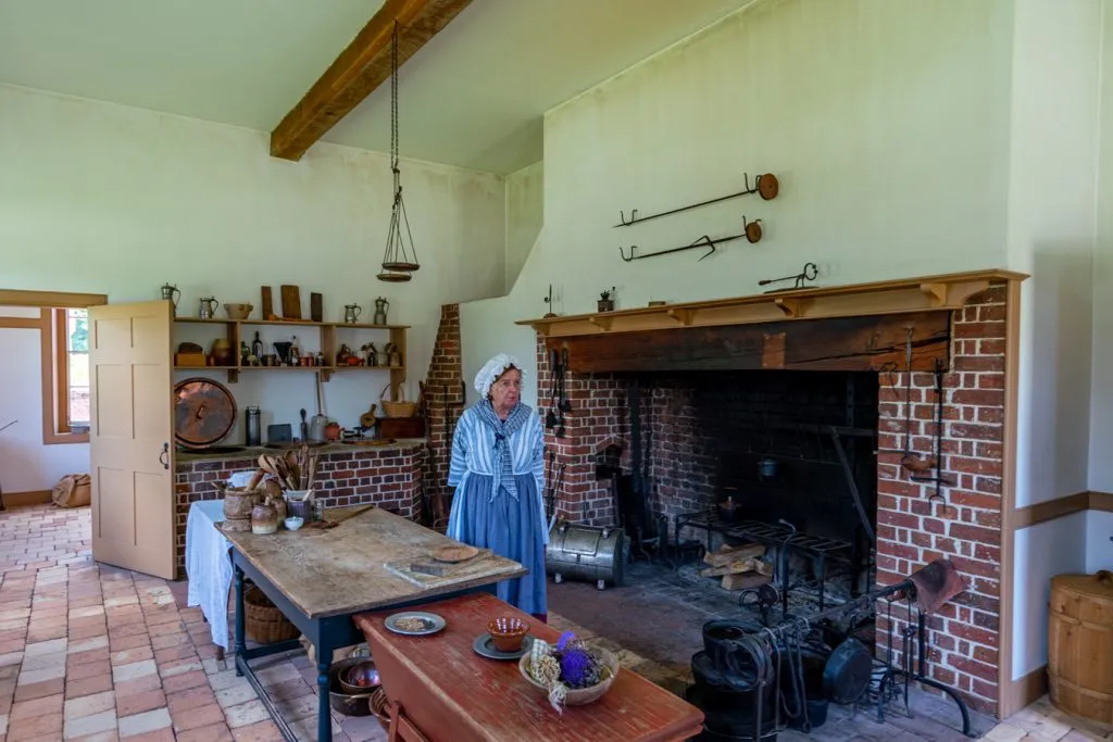 costumed tour guide at tryon palace explaining 18th century kitchen