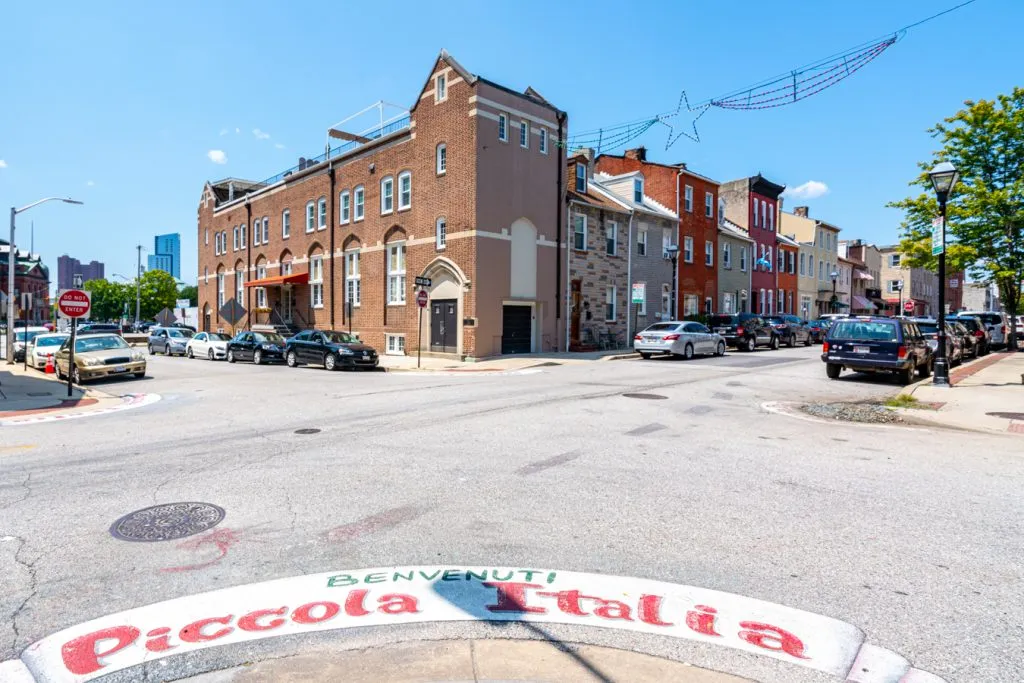 view of little italy baltimore with "piccola italia" painted on the street in the foreground