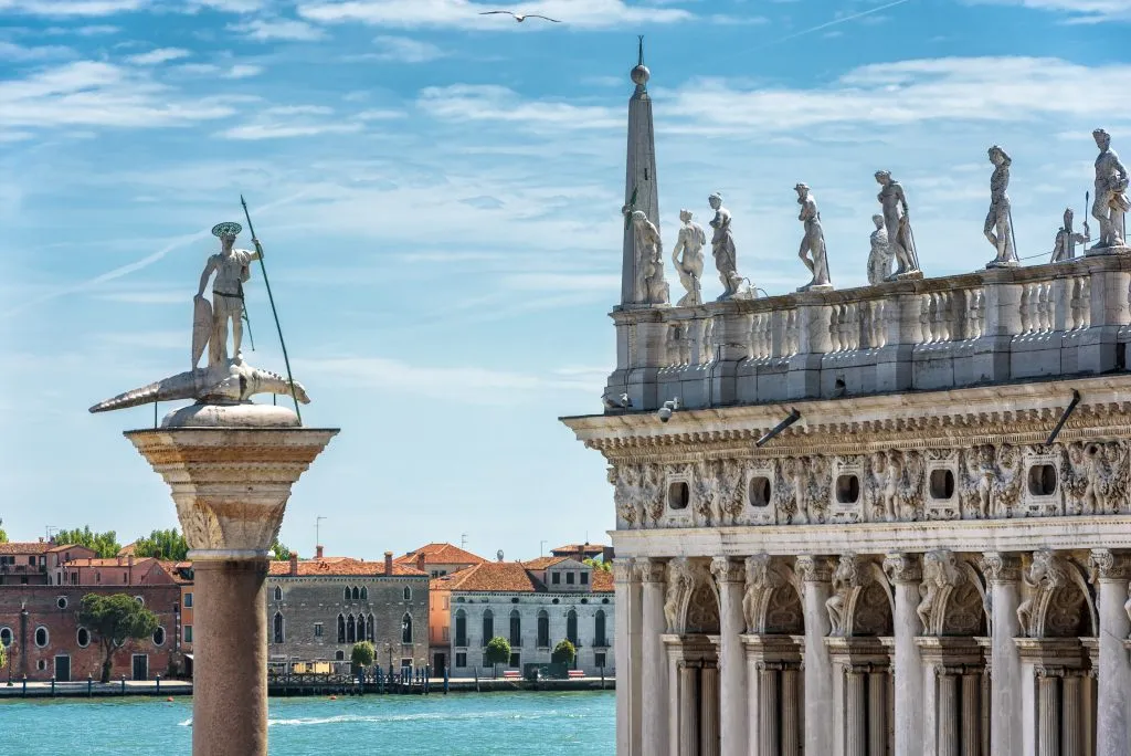 view of statue of san todaro in venice italy with lagoon in the background