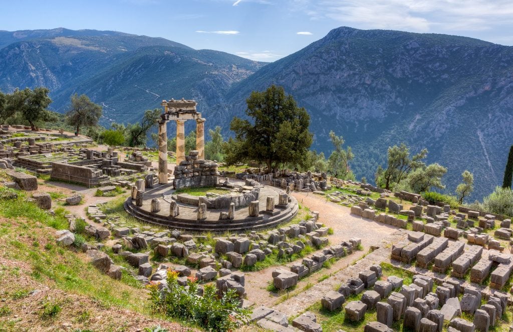 ruins of delphi greece with mountains in the background