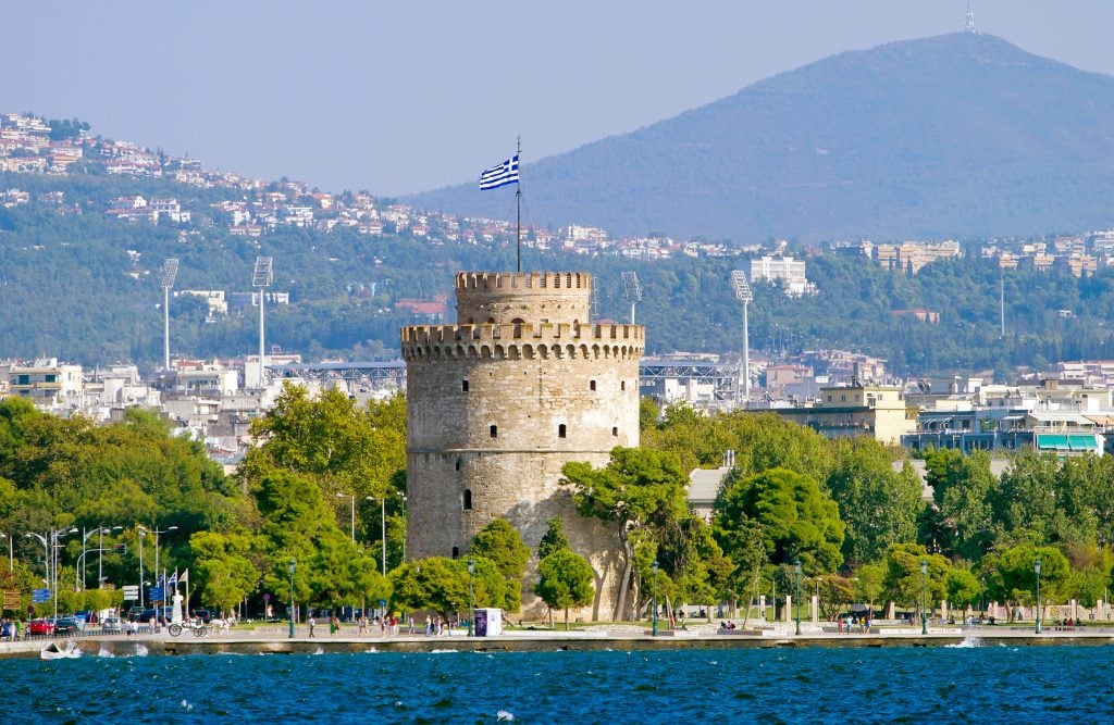 view of stone tower in thessaloniki greece as seen from across the water, a cool stop on a 7 day greece trip