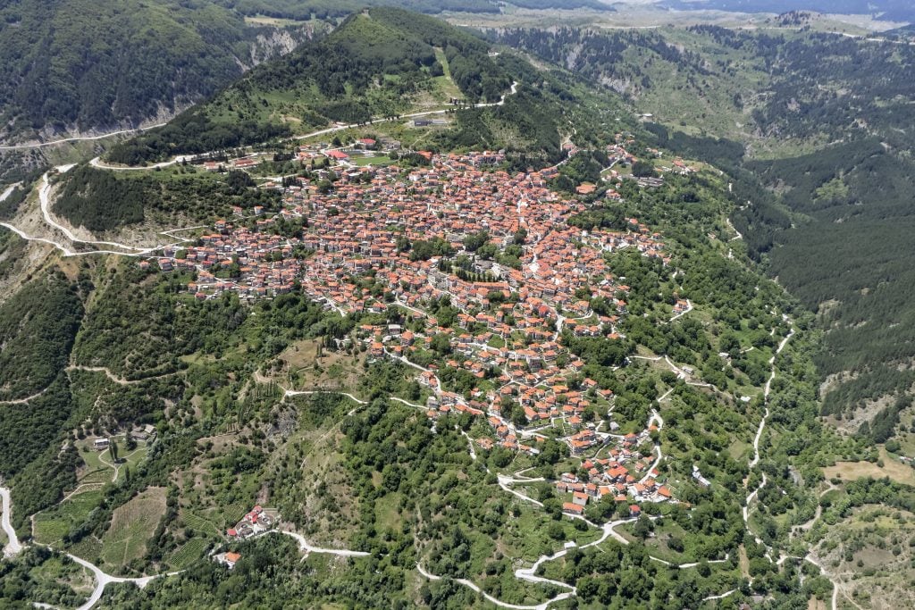 aerial view of Metsovo greece with winding mountain roads leading away from it, a hidden gem when visiting greece in 7 days