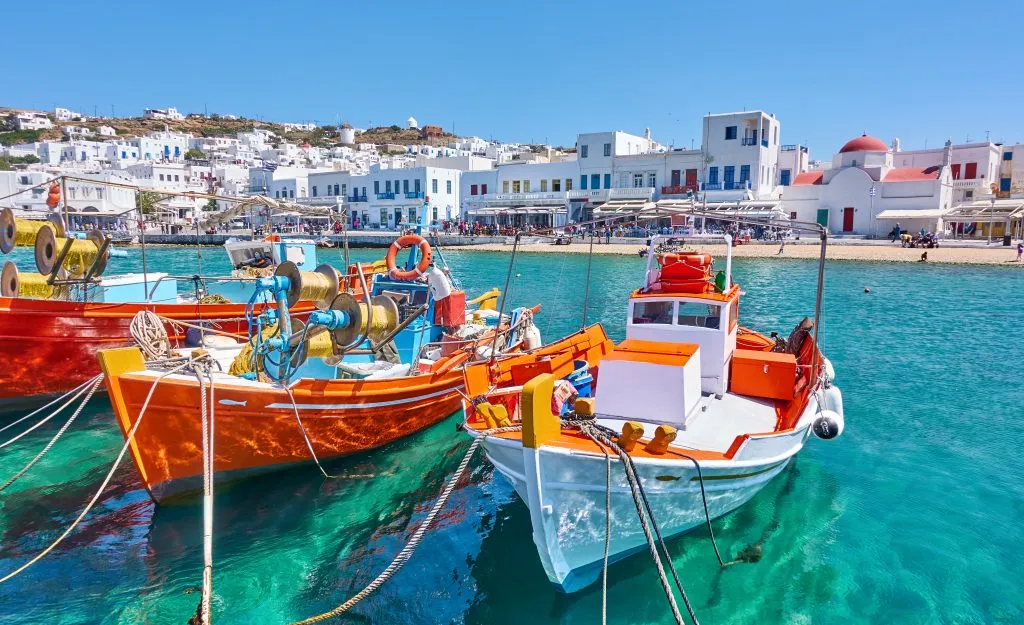 fishing boats in the harbor of mykonos, one of the most popular stops on a greece island hopping itinerary 7 days