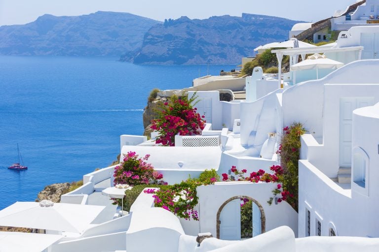 view of whitewashed village on santorini with sea in the background, one of the best itinerary for greece in 7 days travel destinations