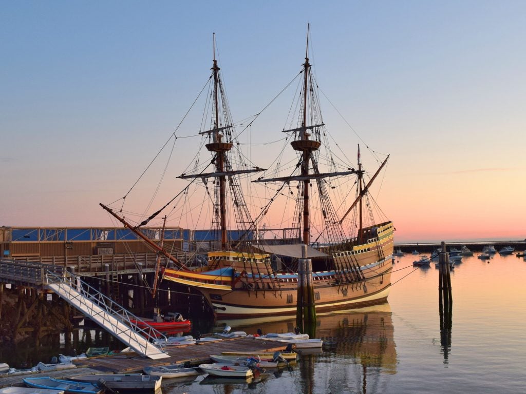 replica of mayflower ship at sunset in plymouth ma, one of the best usa november vacation spots