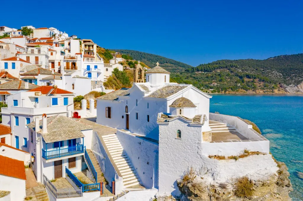 whitewashed village along the water in skopelos greece