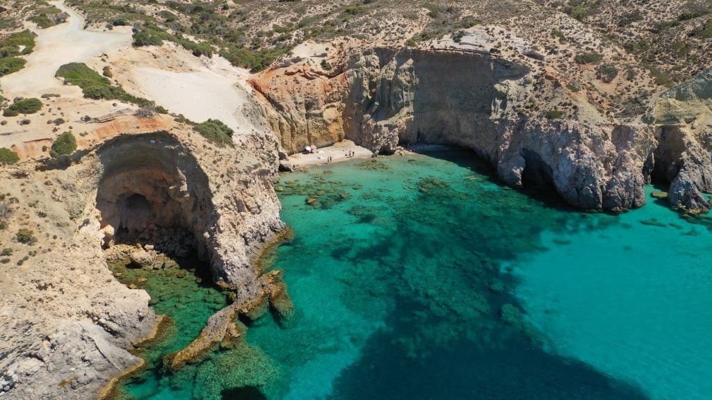 view of rocky cliffs and bright blue water, a fantastic view during an itinerary greece in 7 days